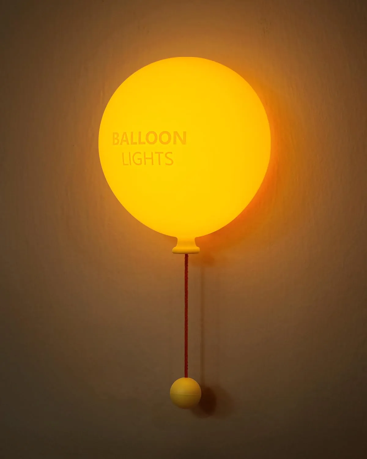 Minimal balloon wall light with warm glow